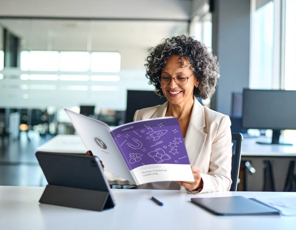 woman in a corporate office using her human-centered leadership training material